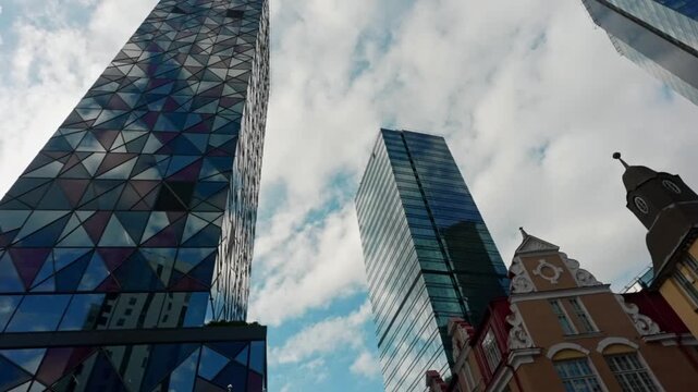 Modern skyscrapers rising above high-rise financial district buildings.