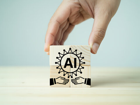 Hand holding wooden block with ai icon