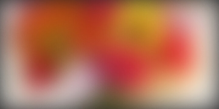 Abstract blurred background with warm orange and red color gradients.