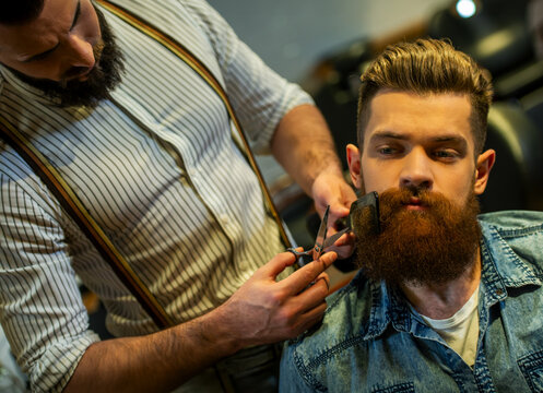 Barber Trimming Beard.