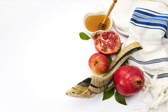 Rosh hashanah symbols with shofar, apples, pomegranates, and honey