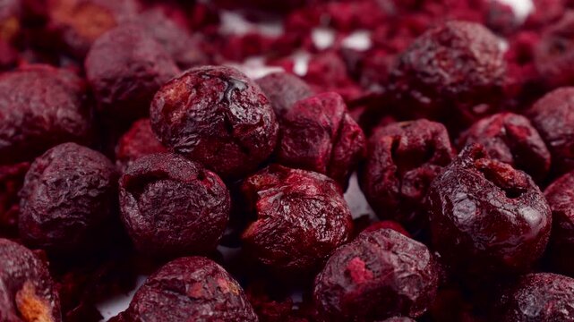 Red whole freeze dried cherry berries falling down close up