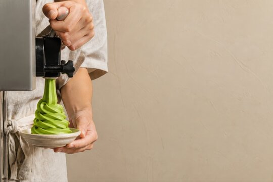 Matcha soft serve being dispensed into a dessert bowl