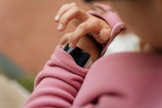 Person using smartwatch with pink sleeve