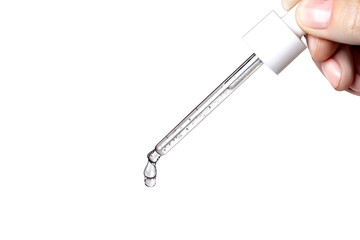 Obraz premium Cosmetic Pipette with serum in hand. Drips drop isolated on g white, close up