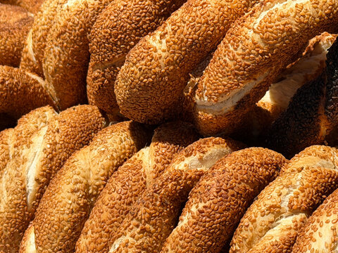 Close-up of fresh traditional Turkish simit bread covered with sesame seeds, iconic Istanbul street food and authentic Turkish bakery culture