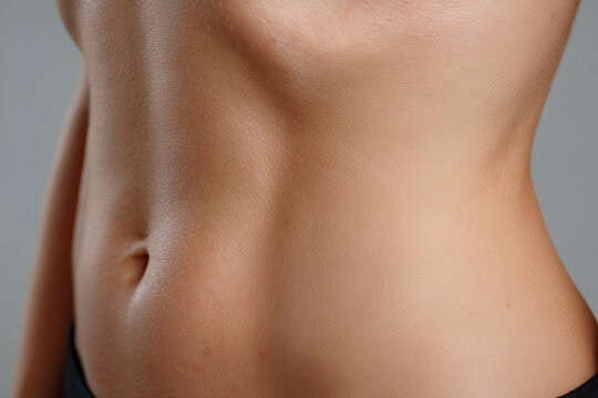 Slim waist abdomen belly navel skin fold torso smooth skin female body midriff close up