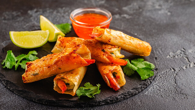 Fried spring rolls with shrimps served with sauce and lime