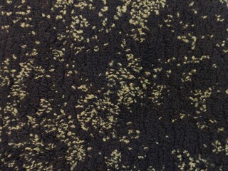 Macro texture of dark cozy fleece fabric with light green speckled pattern © AgusOe