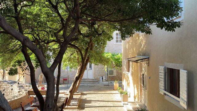Sunny courtyard of a historic house in an old European town, charming architecture and peaceful summer atmosphere
