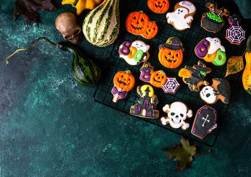 Halloween cookies in shape of bat ghost jack-o-lantern and skull
