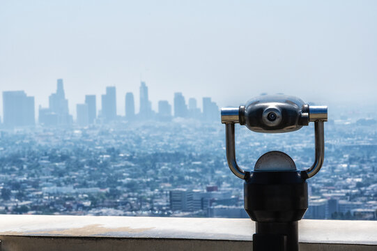 Panoramic view of Downtown Los Angeles skyline from Griffith Observatory with public viewing telescope in California, USA