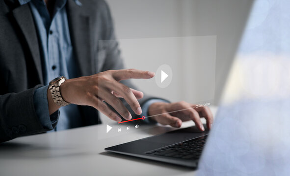 Businessman touching a virtual screen with his hands for online streaming watch videos on the internet online webinars internet education e-learning concept