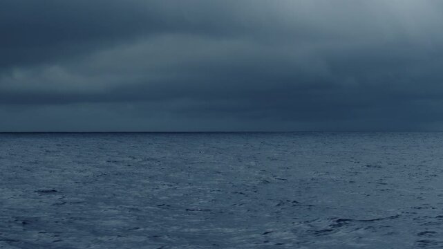 Dark Atlantic Ocean and stormy clouds as seen from the moving sailing boat