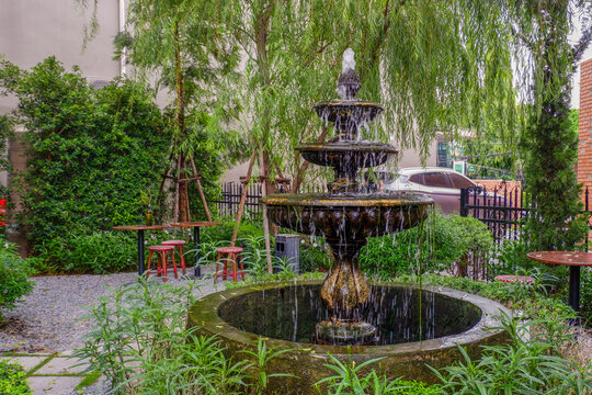 Luxury Fountain at green garden in house outdoor garden,Scenic View of a Beautiful English Style Landscape Garden in summer,selective focus.