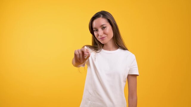 Smiling woman holding invisible dental aligner for orthodontic treatment