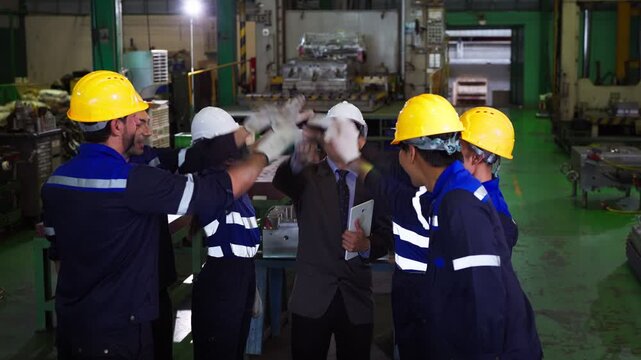 Industrial team stacking hands together in factory for unity and teamwork. ideal for corporate presentations, manufacturing reports, and engineering recruitment campaigns.