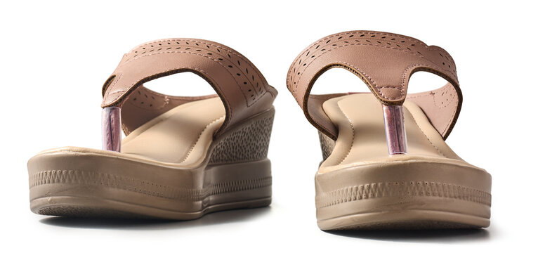 pair of beige wedge sandals isolated white background, women footwear with platform heel and textured straps in close-up side view