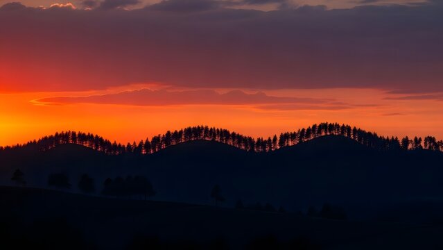 Orange clouds drift over rolling forests.