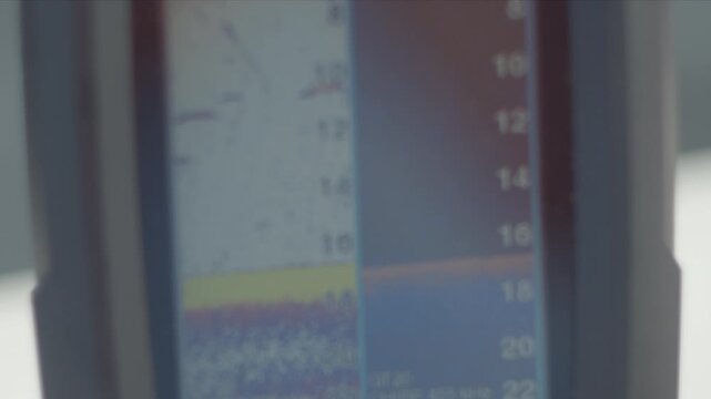 Close up view of the fish finder on the boat moving on the lake