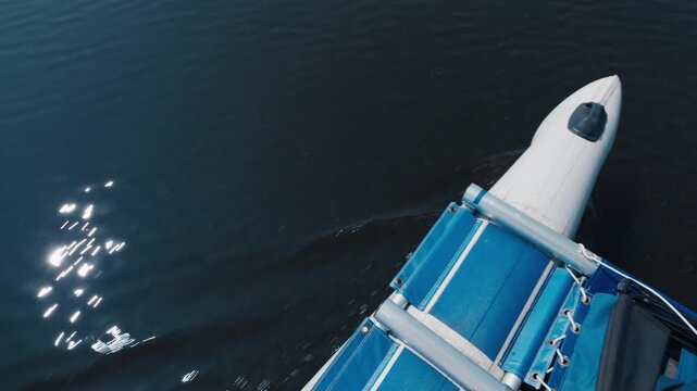 Detail of the inflatable boat moving on the lake