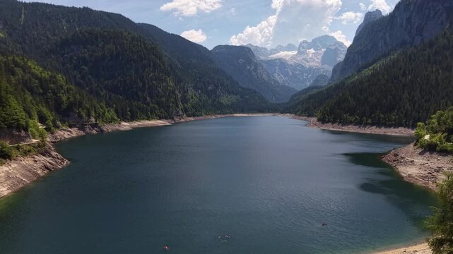 Aerial View Gosau Alpine Lake Beneath Dachstein Mountains

Drone footage reveals tranquil mountain waters framed by forests and dramatic peaks, Gosau, Austria, 11 August 2026.

