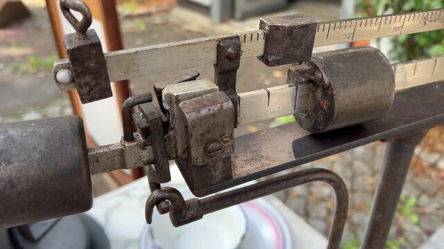 Close View Along Old Mechanical Beam Scale with Sliding Weights and Graduated Measuring Bar