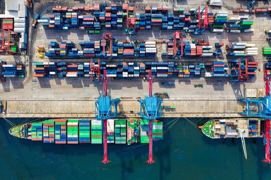 Aerial view of container cargo ship loading in industrial seaport terminal
