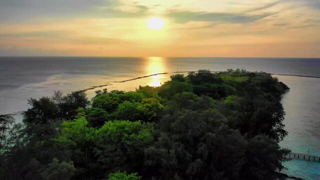Aerial View of Tropical Island Resort with Lush Forest at Sunset
