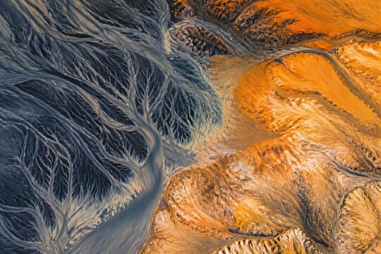 Aerial view showing braided river and mineral rich terrain