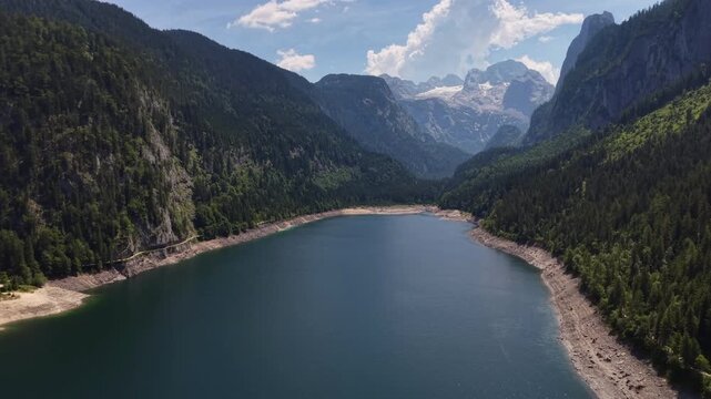 Aerial View Gosau Alpine Lake Beneath Dachstein Mountains

Drone footage reveals tranquil mountain waters framed by forests and dramatic peaks, Gosau, Austria, 11 August 2026.

