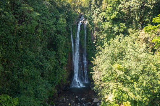 Aerial View of Gitgit Waterfall Surrounded by Lush Tropical Forest in Bali, Indonesia