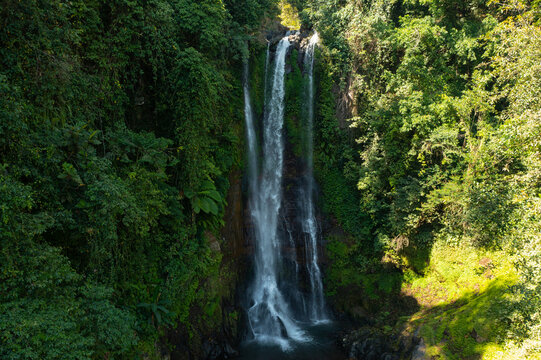 Aerial View of Gitgit Waterfall Surrounded by Lush Tropical Forest in Bali, Indonesia