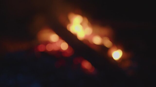 Bonfire burns in the wild area. Naturally blurred out of focus footage