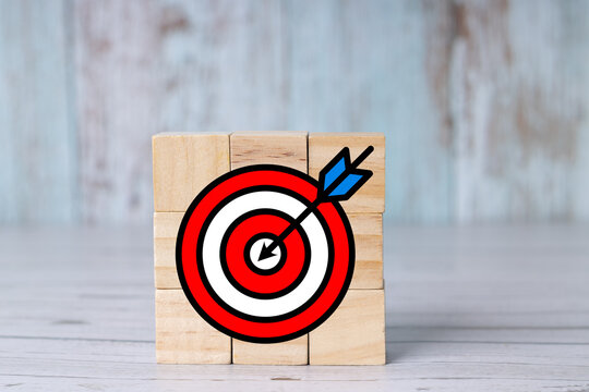 Strategic approach and achievement of business or personal goals; target icon on wooden cubes.