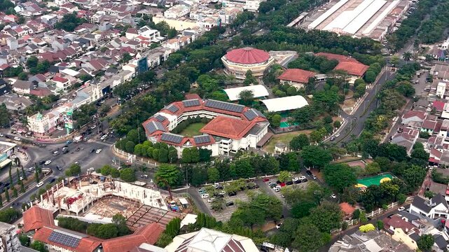 Aerial view of the building complex along Jalan Letnan Sutopo with solar panels on rooftops and surrounding urban greenery in Kecamatan Serpong, Banten, Indonesia.