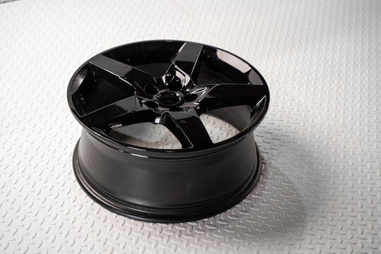 Black alloy car wheel isolated on white background