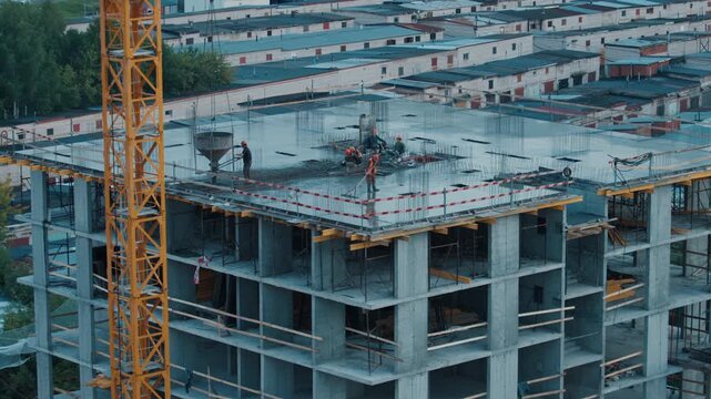 Group of people work on the constriction site of the living building in the city
