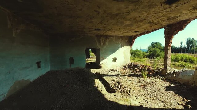 Building in ruins. Flying through the holes in the brick building walls.