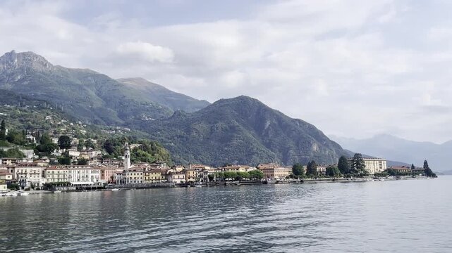Scenic view of Lake Como and mountains with boats and plants in Italy