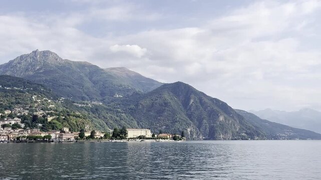 Scenic view of Lake Como and mountains with boats and plants in Italy