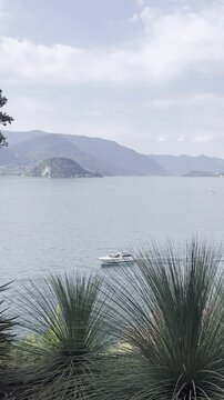 Scenic view of Lake Como and mountains with Bellagio and a boat in the distance, Italy