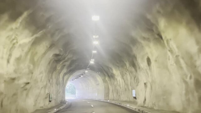 Driving through a mountain road tunnel near Lake Como, Italy