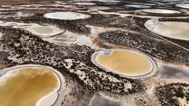 Aerial view of salt lakes in Damboring Nature Reserve with white salt crusts and arid vegetation in West Ballidu, Western Australia, Australia.