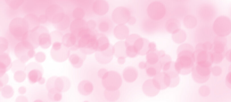 Soft pink bokeh background with blurred circles of light, creating a dreamy and romantic atmosphere for design projects and celebrations.