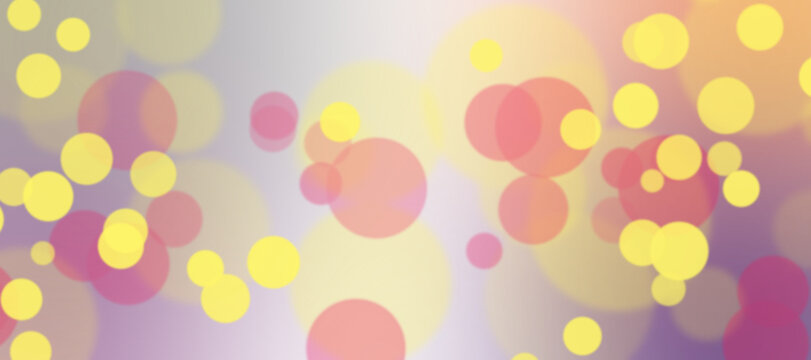 Abstract background with soft bokeh lights in yellow, pink and purple colors. Festive blurred circles for holiday design, wallpaper or greeting card.