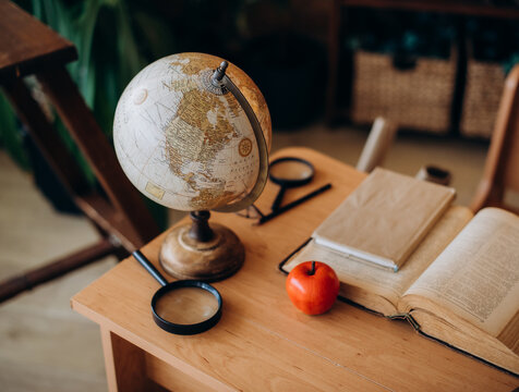 School Desk with Globe, Open Book and Pencil