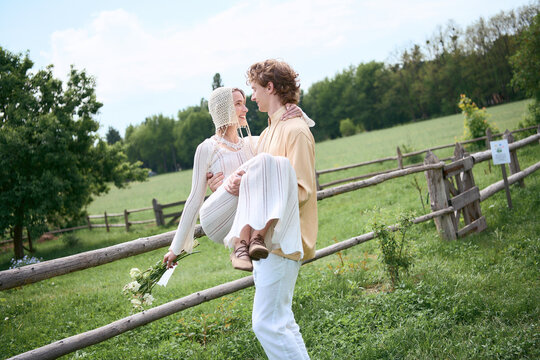 Romantic couple embraces nature in boho outfits under the summer sky