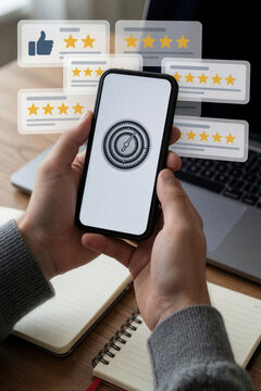 Person holds smartphone with gear icon on screen. Floating user reviews with star ratings, thumbs up icon appear in air. Customer feedback, app settings interface concept on desk with laptop,