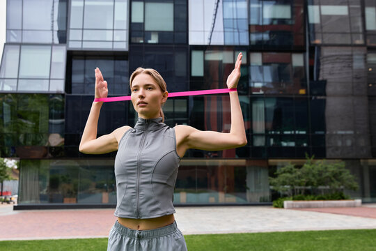 Urban workout session as a young woman exercises in a vibrant city setting